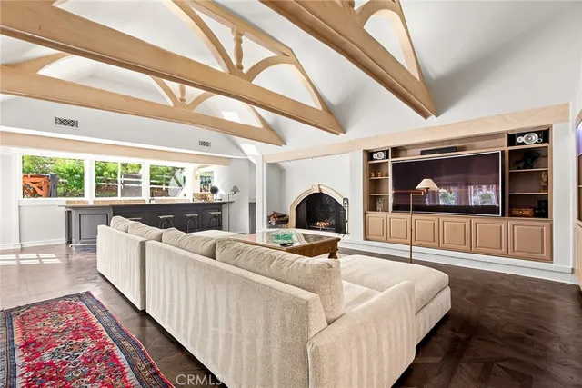 a living room with furniture a rug and a floor to ceiling window