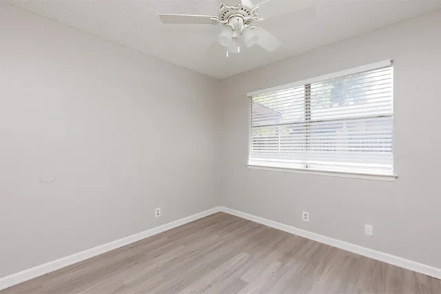 wooden floor in an empty room with a window