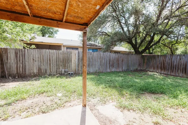 a backyard of a house with green landscape