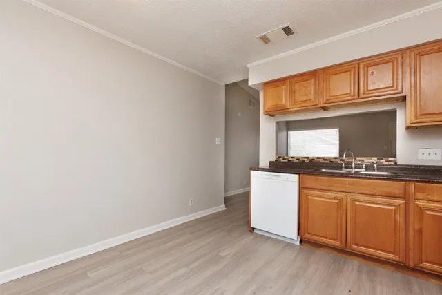a kitchen with granite countertop white cabinets and white appliances