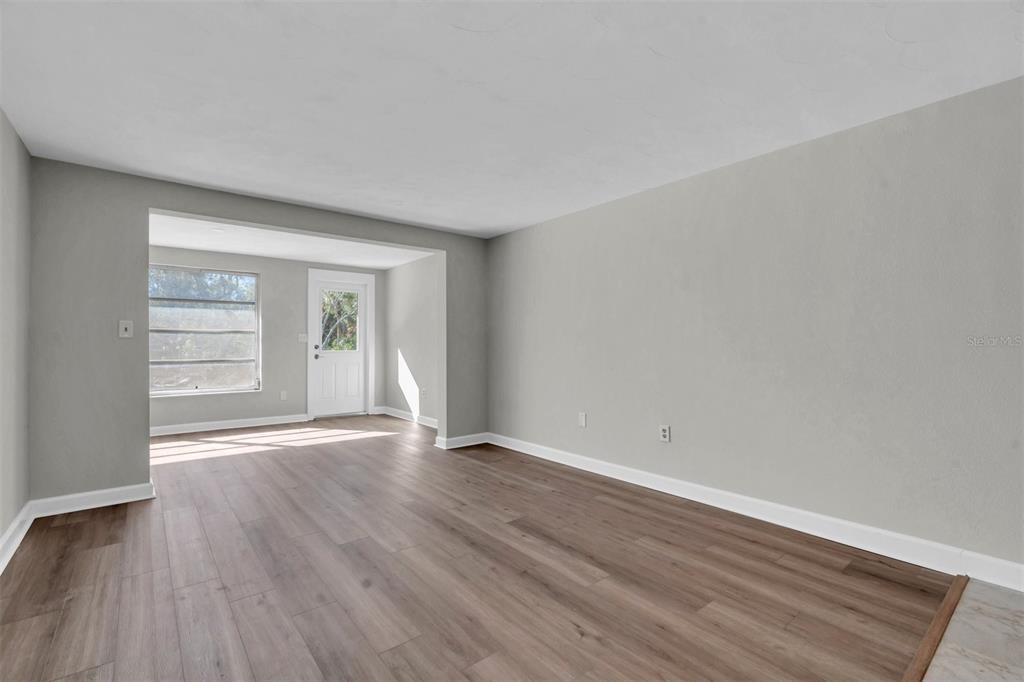 4343 Summersun Drive, Unit 4343 New Port Richey, FL 34652 - Photo 15 of 50 an empty room with wooden floor and windows