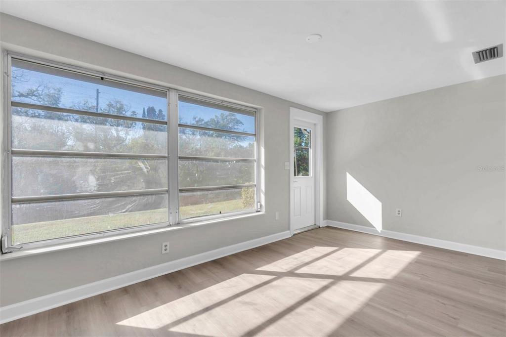 4343 Summersun Drive, Unit 4343 New Port Richey, FL 34652 - Photo 16 of 50 a view of empty room with wooden floor and fan