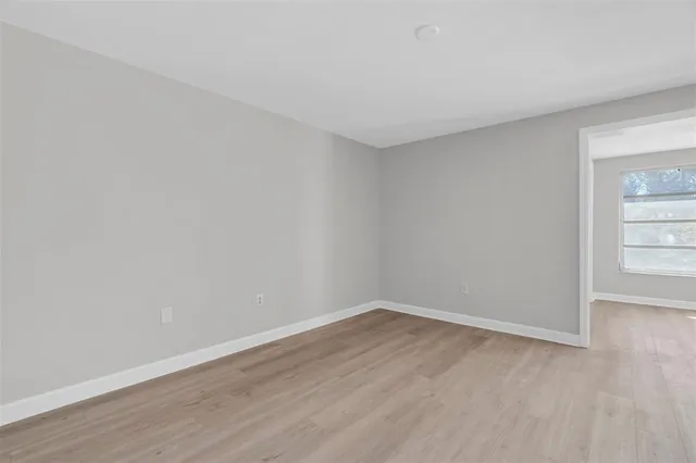 an empty room with wooden floor