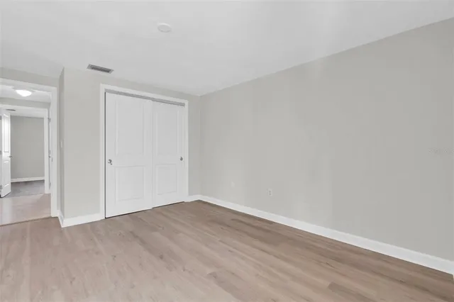 a bathroom with a granite countertop bathtub sink vanity mirror and toilet
