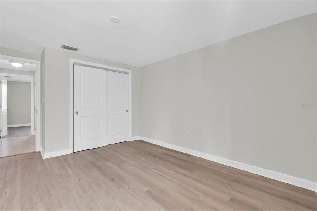4343 Summersun Drive, Unit 4343 New Port Richey, FL 34652 - Photo 22 of 50 an empty room with wooden floor