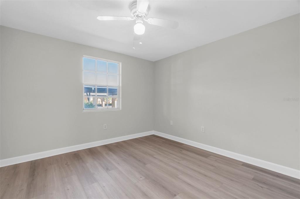 4343 Summersun Drive, Unit 4343 New Port Richey, FL 34652 - Photo 25 of 50 wooden floor in an empty room with a window