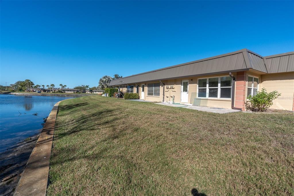 4343 Summersun Drive, Unit 4343 New Port Richey, FL 34652 - Photo 27 of 50 a view of a house with a yard