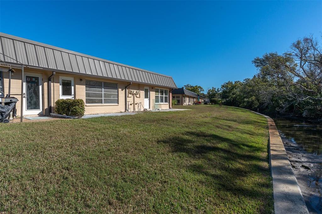 4343 Summersun Drive, Unit 4343 New Port Richey, FL 34652 - Photo 29 of 50 a view of a house with a yard