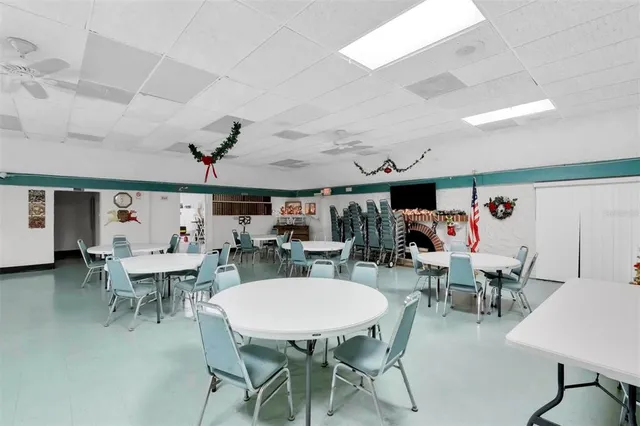 a living room with furniture pool table and window