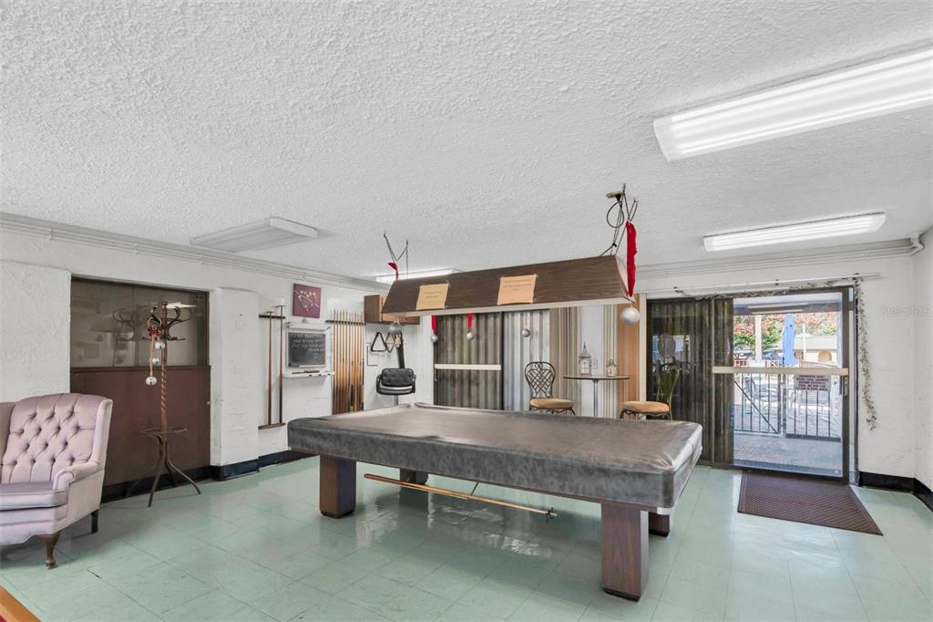 4343 Summersun Drive, Unit 4343 New Port Richey, FL 34652 - Photo 44 of 50 a living room with furniture pool table and window