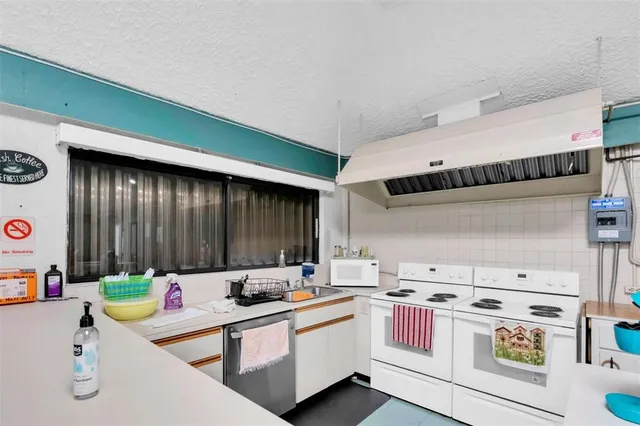 a living room with furniture and a book shelf