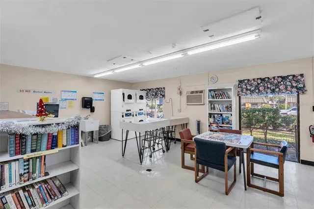 a living room with furniture a rug and a bookshelf