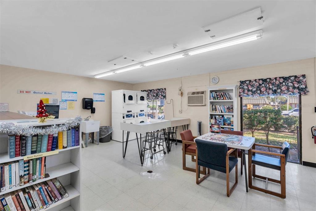 4343 Summersun Drive, Unit 4343 New Port Richey, FL 34652 - Photo 46 of 50 a living room with furniture and a book shelf