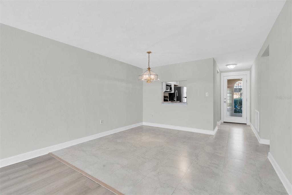 4343 Summersun Drive, Unit 4343 New Port Richey, FL 34652 - Photo 10 of 50 an empty room with wooden floor and windows