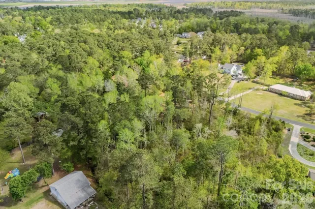 an aerial view of residential house with parking space and trees