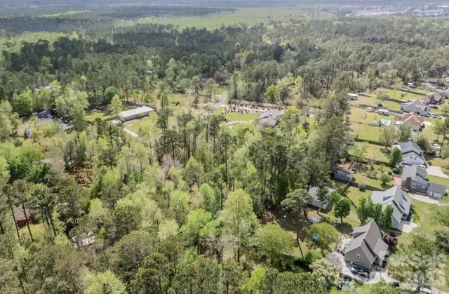 an aerial view of residential house with parking space and trees
