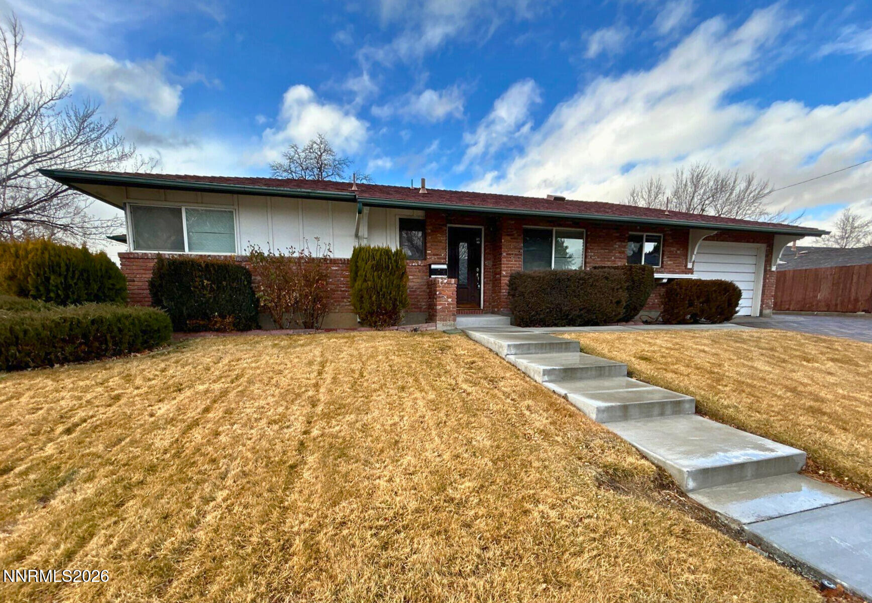 1010 Tyler Way Sparks, NV 89431 - Photo 1 of 11 a front view of a house with a yard
