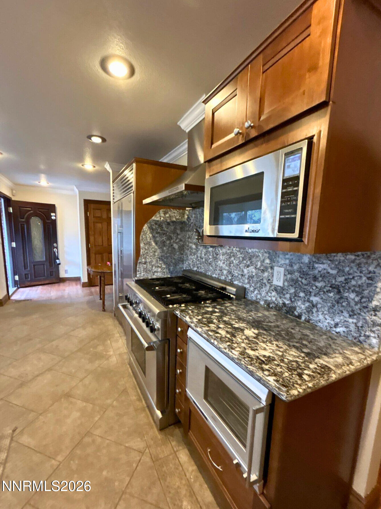 1010 Tyler Way Sparks, NV 89431 - Photo 6 of 11 a kitchen with granite countertop a stove and a microwave