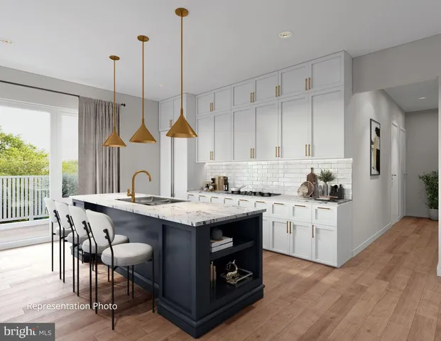 a kitchen with stainless steel appliances granite countertop a sink a stove a refrigerator and island with wooden floor