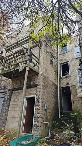 front view of a stone house with a small yard