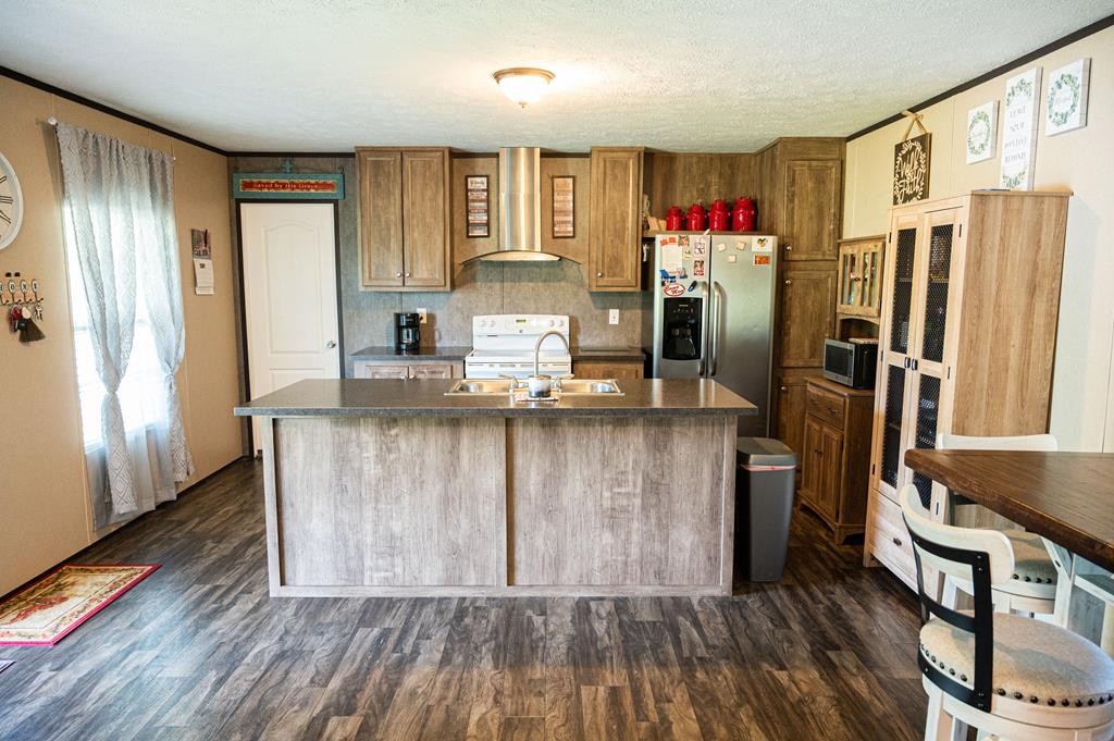 4526 Mt Pleasant Road Cohutta, GA 30710 - Photo 13 of 24 a kitchen with stainless steel appliances granite countertop a refrigerator and a sink