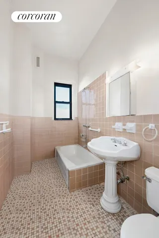 a bathroom with a sink a toilet and mirror