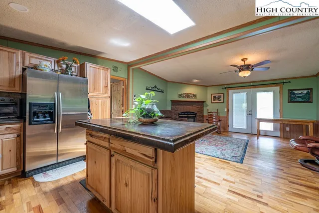 a kitchen with stainless steel appliances granite countertop a sink a stove and a refrigerator