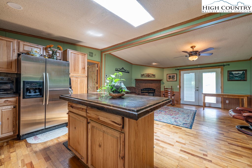 285 Roaring Fork Road Todd, NC 28684 - Photo 13 of 41 a kitchen with stainless steel appliances granite countertop a sink a stove and a refrigerator