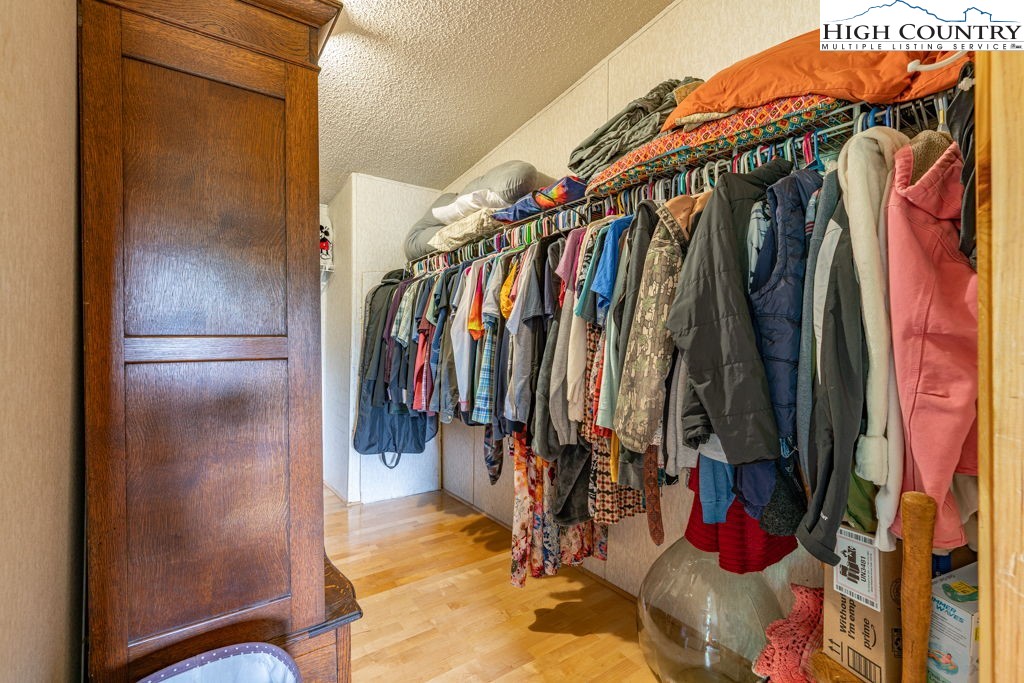 285 Roaring Fork Road Todd, NC 28684 - Photo 22 of 41 a view of walk in closet with clothes