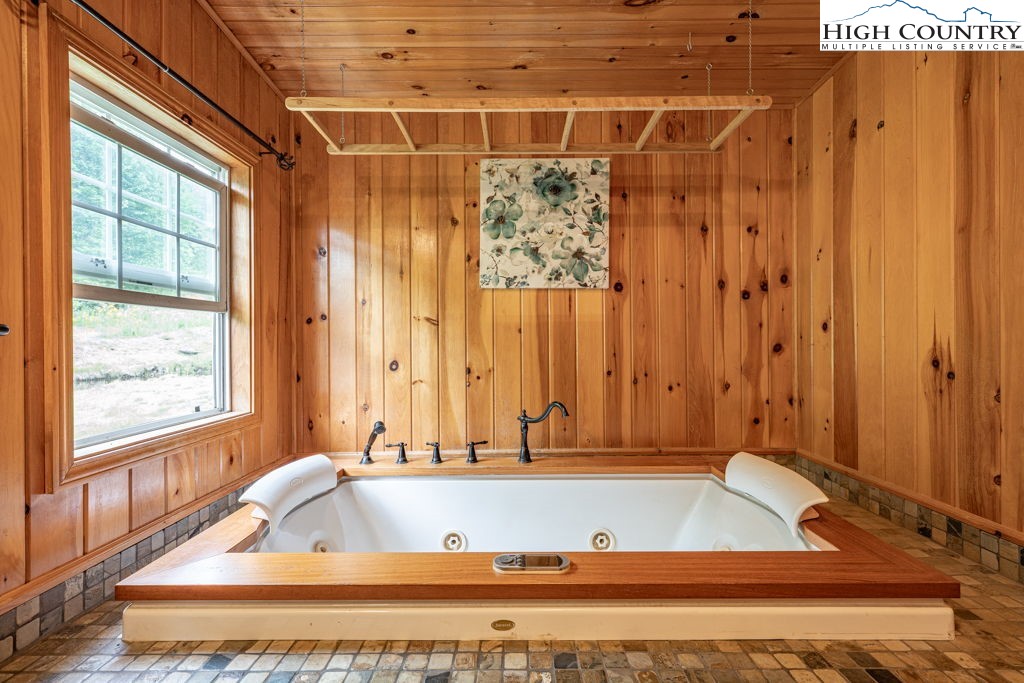 285 Roaring Fork Road Todd, NC 28684 - Photo 25 of 41 a bathroom with a bathtub and shower