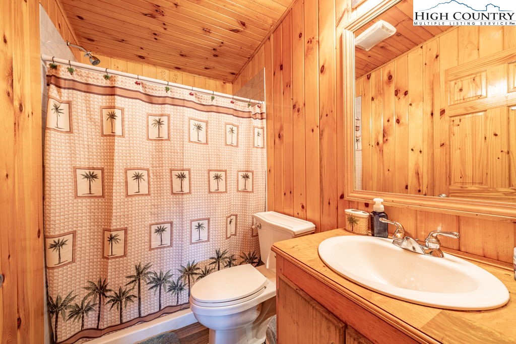 285 Roaring Fork Road Todd, NC 28684 - Photo 32 of 41 a bathroom with a granite countertop sink toilet and shower