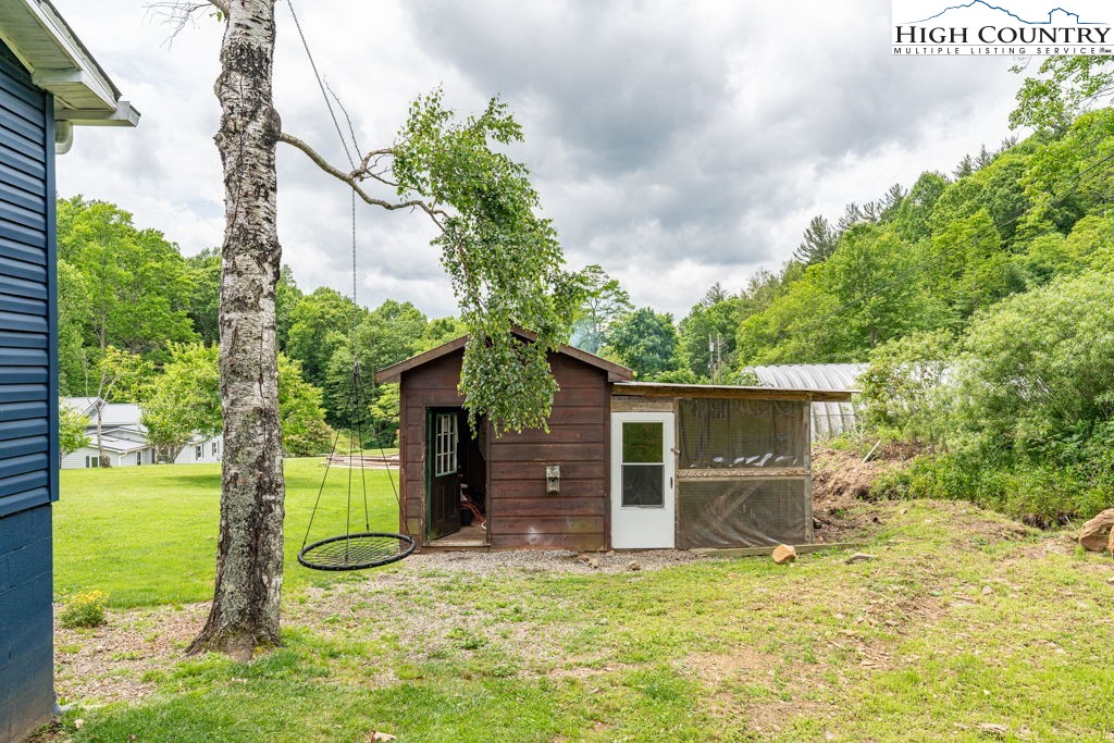 285 Roaring Fork Road Todd, NC 28684 - Photo 38 of 41 a view of a house with backyard and a tree