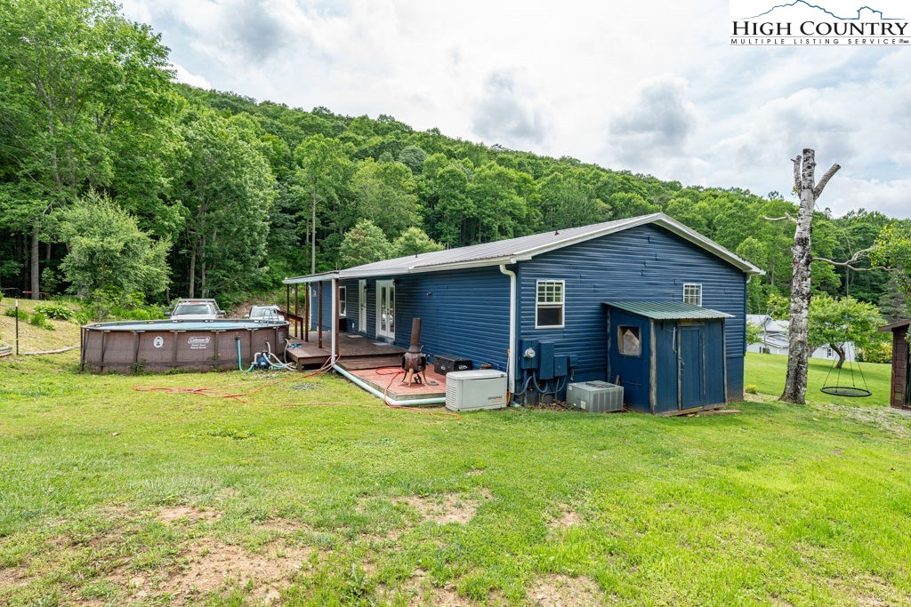 285 Roaring Fork Road Todd, NC 28684 - Photo 5 of 41 a backyard of a house with table and chairs