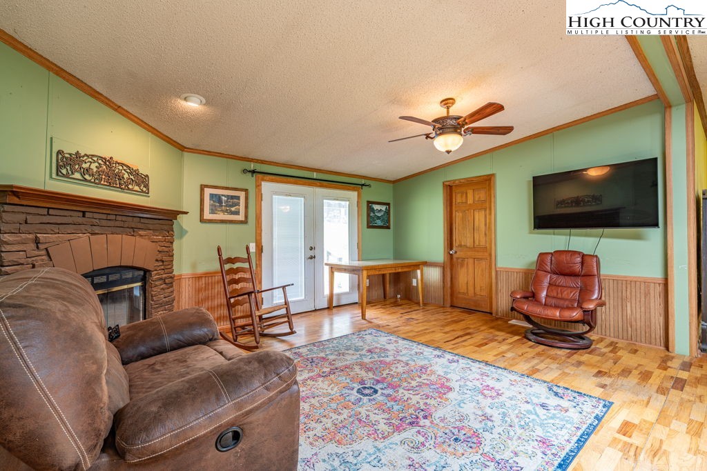 285 Roaring Fork Road Todd, NC 28684 - Photo 10 of 41 a living room with furniture and a flat screen tv