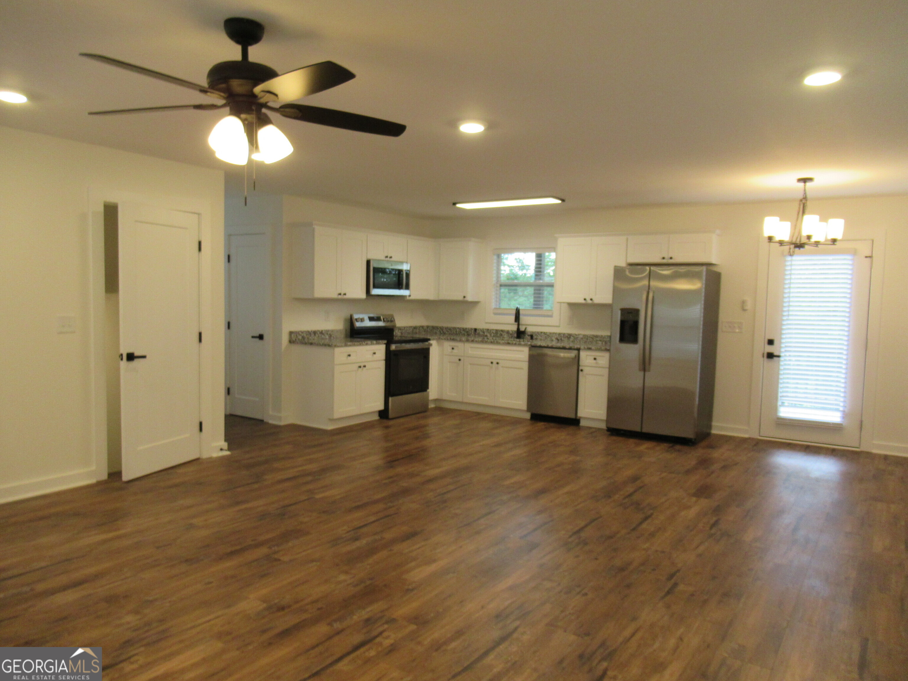 765 Old Kerns Road Dawsonville, GA 30534 - Photo 7 of 36 a kitchen with stainless steel appliances granite countertop a refrigerator and a stove top oven