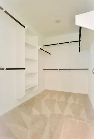 a view of a dry back white kitchen with a refrigerator