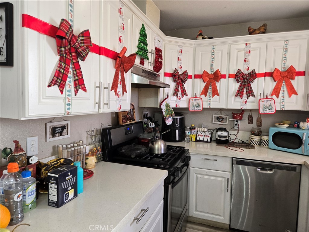 40525 166th Street East Lancaster, CA 93535 - Photo 8 of 30 a kitchen with stainless steel appliances granite countertop a refrigerator and a stove