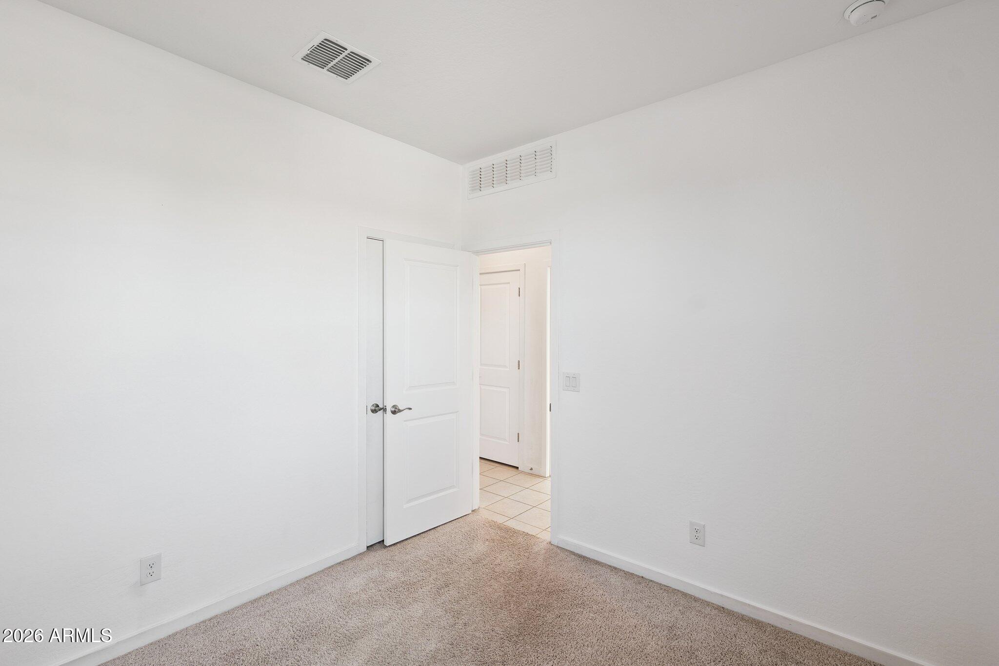 4313 West Allen Street Laveen, AZ 85339 - Photo 12 of 22 a view of a closet area with wooden floor