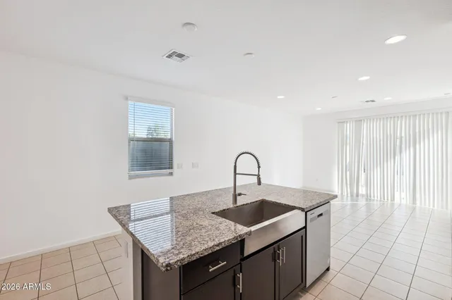 a kitchen with a sink dishwasher and cabinets