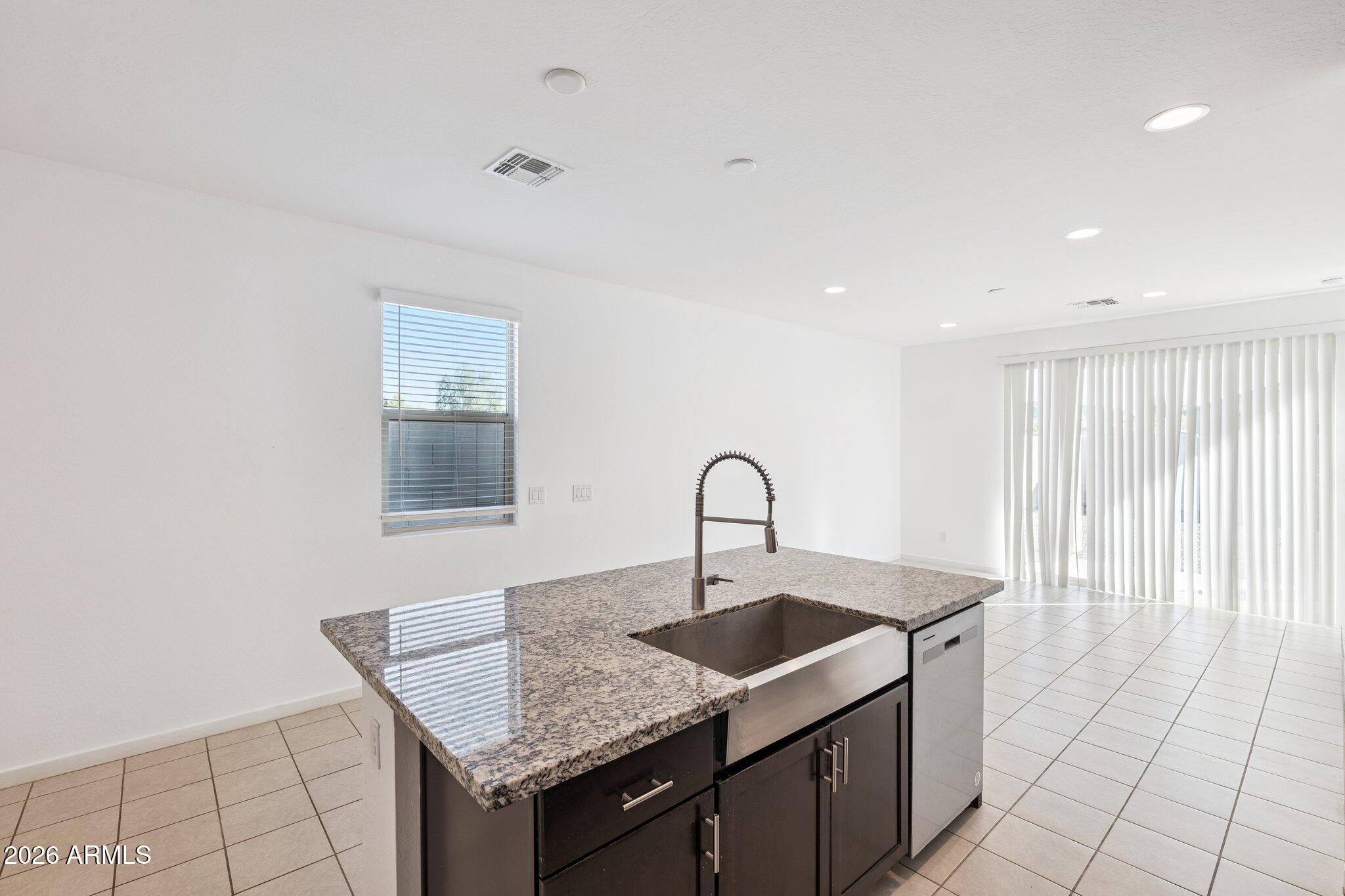 4313 West Allen Street Laveen, AZ 85339 - Photo 5 of 22 a kitchen with a sink dishwasher and cabinets