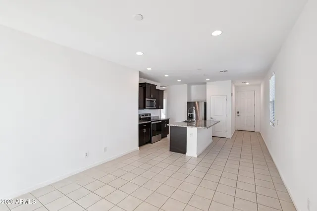 a view of kitchen with refrigerator sink and stove