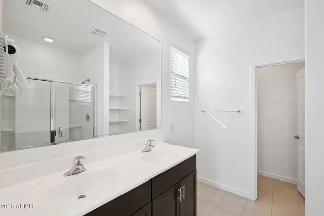 a bathroom with a sink a shower and a mirror