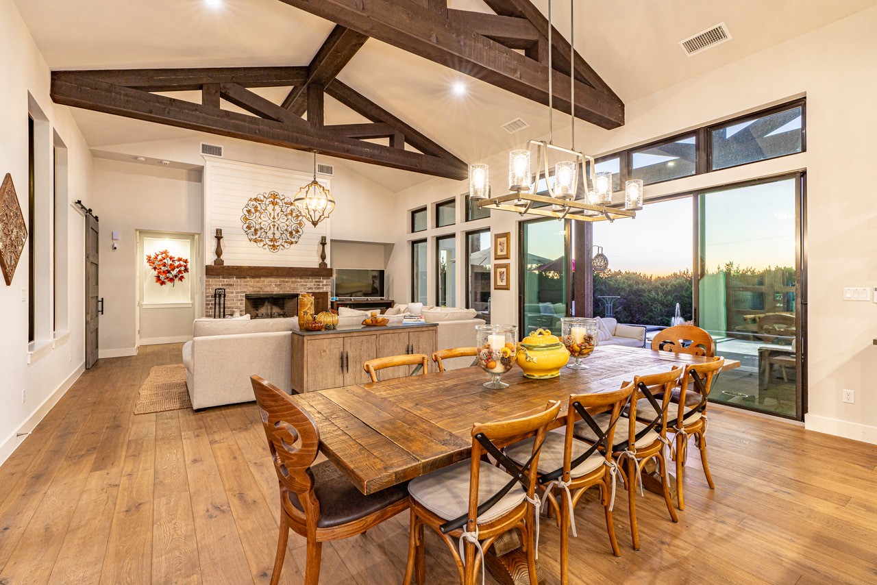 26604 Hunters Grove Court Spicewood, TX 78669 - Photo 6 of 8 a view of a dining room with furniture wooden floor and chandelier