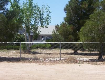 11560 Mohawk Road Apple Valley, CA 92308 - Photo 1 of 1 a backyard of apartments with large trees