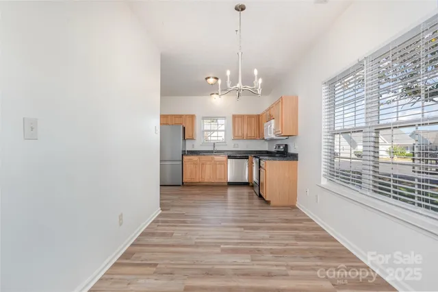 a view of a kitchen with a sink and wooden floor