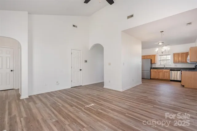 a view of a kitchen with wooden floor and a sink