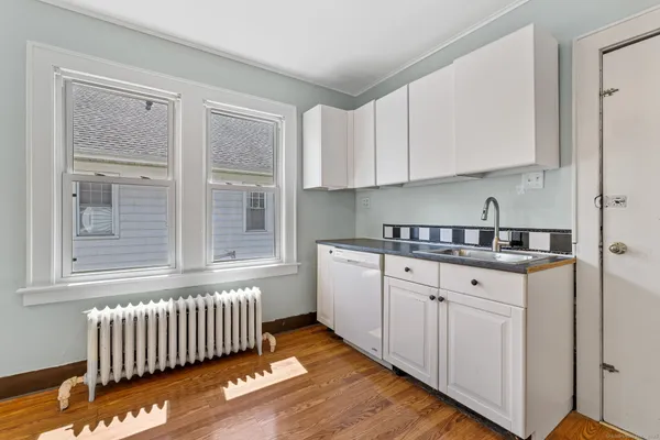 a kitchen with sink and cabinets