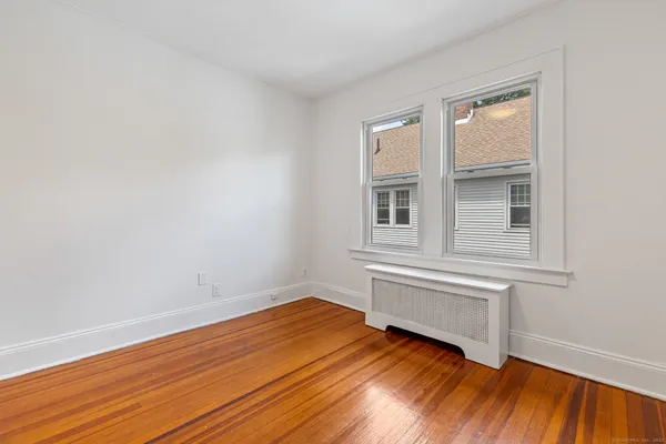 a view of a room with wooden floor and window