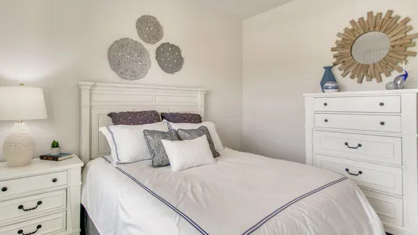 a bedroom with a bed and cabinets