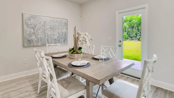 a view of a dining room with furniture and window